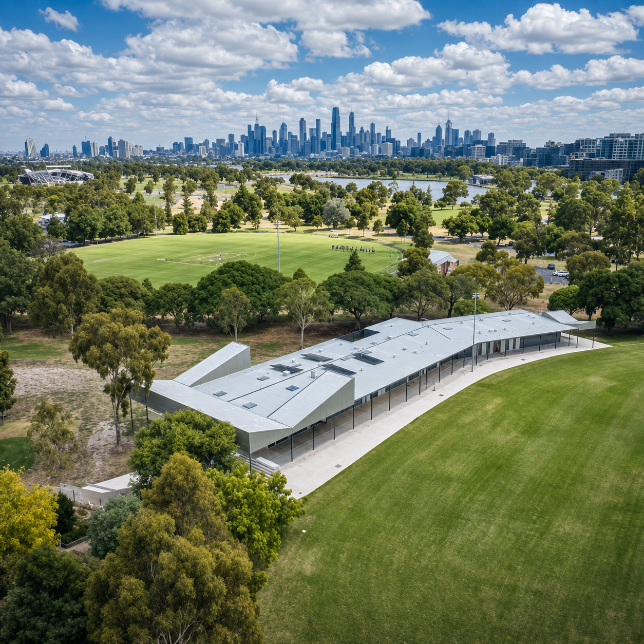Parks Victoria / SRV Projects — aerial view of pavilion within parkland, Melbourne skyline beyond